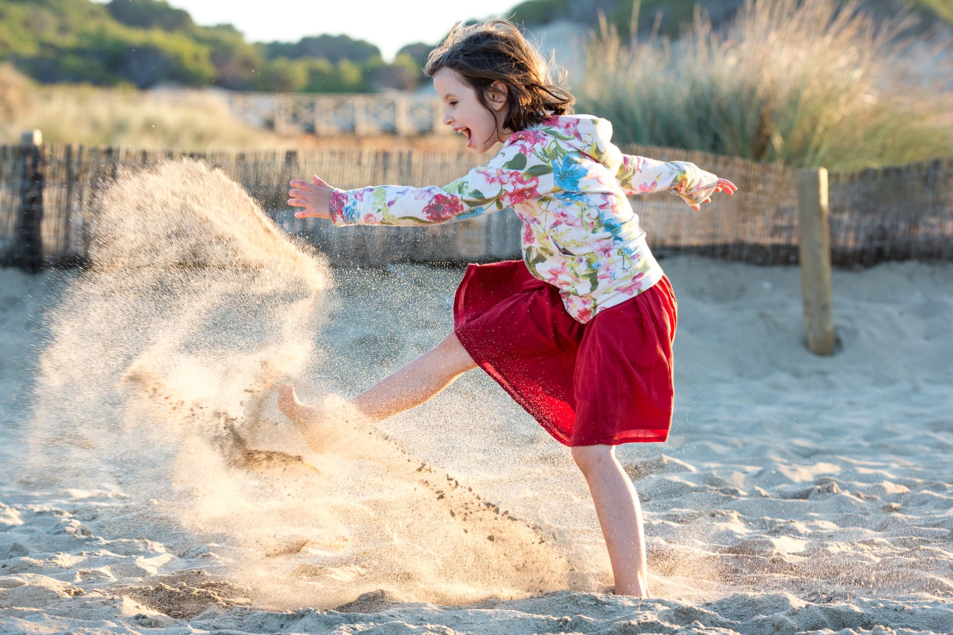 petite fille qui tape dans le sable reportage photo du quotidien dans une famille à Mallorca
