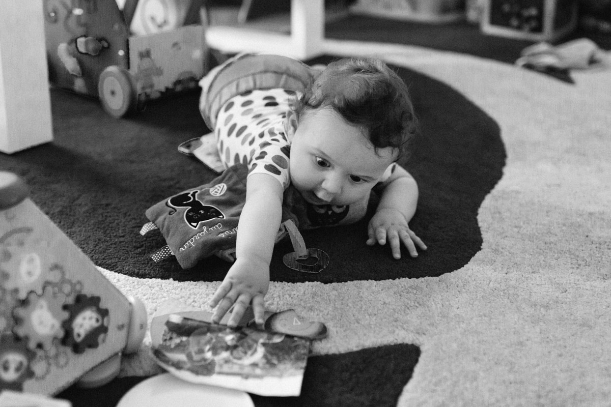 reportage à la maison photo de famille à Rueil Malmaison (92) bébé attrape une photo